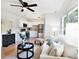 Well-lit living area with a modern kitchen, stylish furnishings, and hardwood flooring at 8114 N 11Th St, Tampa, FL 33604