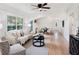 Bright living room featuring hardwood floors, a ceiling fan, and natural light at 8114 N 11Th St, Tampa, FL 33604