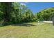 Spacious backyard with mature trees and a pool sized hardscape at 8406 Glengarry Pl, Trinity, FL 34655