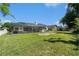 An exterior shot of the rear yard with a large screened-in pool and spa area at 8406 Glengarry Pl, Trinity, FL 34655