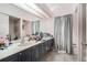 Bathroom featuring tile floors, long double sink, walk-in shower, and window with curtains at 8406 Glengarry Pl, Trinity, FL 34655