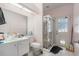 Bathroom featuring tile floors, single sink, walk-in shower, and exterior door at 8406 Glengarry Pl, Trinity, FL 34655