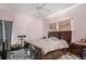 Bedroom featuring tile floors, ceiling fan, curtains, and dark wood furniture at 8406 Glengarry Pl, Trinity, FL 34655