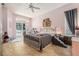 Bedroom with tile flooring, ceiling fan, furnishings, and exterior access to screened-in patio at 8406 Glengarry Pl, Trinity, FL 34655