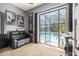 Comfortable bedroom with a sliding glass door leading to the screened-in pool area at 8406 Glengarry Pl, Trinity, FL 34655