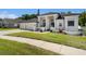 Angle shot of a one-story home with a three car garage, showcasing its manicured lawn at 8406 Glengarry Pl, Trinity, FL 34655