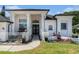 Elegant front entrance of a home with pillars, a gated courtyard, and beautiful landscaping at 8406 Glengarry Pl, Trinity, FL 34655