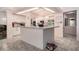 Bright kitchen featuring white cabinets, an island, and modern appliances and tile floors at 8406 Glengarry Pl, Trinity, FL 34655