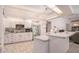 Spacious kitchen with ample cabinet space, a breakfast bar, and stainless steel refrigerator at 8406 Glengarry Pl, Trinity, FL 34655