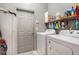 Laundry room featuring washer, dryer, shelves, cleaning supplies, and door at 8406 Glengarry Pl, Trinity, FL 34655