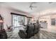 Open-concept living area with tile flooring, opening up to the kitchen and outdoor patio at 8406 Glengarry Pl, Trinity, FL 34655