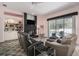 Inviting living room with a black brick fireplace, built-in shelving, and access to the pool at 8406 Glengarry Pl, Trinity, FL 34655