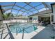 A beautiful private pool and spa in screened enclosure with lounge seating at 8406 Glengarry Pl, Trinity, FL 34655
