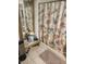 Bathroom with a decorative shower curtain and gold-trimmed mirror at 9481 Patrick St, Brooksville, FL 34601