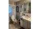 Bathroom featuring a toilet, sink, and decorative wallpaper at 9481 Patrick St, Brooksville, FL 34601