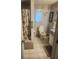 Full bathroom featuring toilet, shower with curtain, and vanity sink at 9481 Patrick St, Brooksville, FL 34601