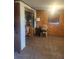 Bedroom with wood paneled walls, window, and carpeted floor at 9481 Patrick St, Brooksville, FL 34601