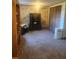 Bedroom with carpeted floor, large safe, and built-in shelving at 9481 Patrick St, Brooksville, FL 34601