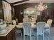 Formal dining area with a crystal chandelier, decorative display cabinet, and seating for eight at 9481 Patrick St, Brooksville, FL 34601