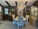 Formal dining area with a crystal chandelier, decorative display cabinet, and seating for eight at 9481 Patrick St, Brooksville, FL 34601
