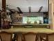 Kitchen with bar seating, wooden beams, and stainless steel refrigerator at 9481 Patrick St, Brooksville, FL 34601
