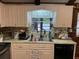 Bright kitchen features light cabinets, a modern sink and faucet, and pleasant natural light at 9481 Patrick St, Brooksville, FL 34601
