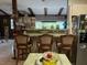 Kitchen with bar seating, wooden beams, and stainless steel refrigerator at 9481 Patrick St, Brooksville, FL 34601