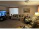 Spacious living room features neutral carpeting, comfortable seating, and a large television at 9481 Patrick St, Brooksville, FL 34601
