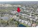 Aerial view of the neighborhood, with ponds, lush greenery, and golf course close by at 1069 Captains Way, Tarpon Springs, FL 34689