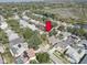 Enjoy this beautiful aerial view of a home with mature trees and landscaping near a lake at 1069 Captains Way, Tarpon Springs, FL 34689