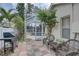 Outdoor patio area with grill, seating, and access to the screened-in pool at 1069 Captains Way, Tarpon Springs, FL 34689