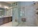 Elegant bathroom with a glass-enclosed shower featuring gray tiling and a built-in seat at 1069 Captains Way, Tarpon Springs, FL 34689