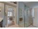 Beautiful bathroom featuring a glass shower and a doorway to a bedroom with plenty of natural light at 1069 Captains Way, Tarpon Springs, FL 34689