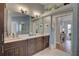 Stylish bathroom featuring double vanity with dark wood cabinets, white countertop, and modern fixtures at 1069 Captains Way, Tarpon Springs, FL 34689