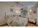 Cozy bedroom with floral bedding, a ceiling fan, and a mirrored closet at 1069 Captains Way, Tarpon Springs, FL 34689