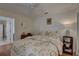 Bright bedroom with floral bedding and wood floors at 1069 Captains Way, Tarpon Springs, FL 34689