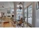 Breakfast nook with glass table and chairs overlooking a screened patio at 1069 Captains Way, Tarpon Springs, FL 34689