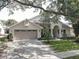Charming single-Gathering home with well-manicured lawn and attached two-car garage at 1069 Captains Way, Tarpon Springs, FL 34689