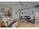 Cozy living room featuring a leather sofa, ceiling fan, and neutral wall colors at 1069 Captains Way, Tarpon Springs, FL 34689