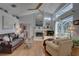 Bright living room with hardwood floors, vaulted ceiling, and access to the pool area at 1069 Captains Way, Tarpon Springs, FL 34689