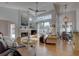 Inviting living room with a fireplace, ceiling fan, and access to outdoor patio at 1069 Captains Way, Tarpon Springs, FL 34689
