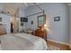Serene bedroom with a four-poster bed, accent mirror, and modern ceiling fan at 1069 Captains Way, Tarpon Springs, FL 34689