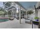 Inviting screened-in pool area with lounge chairs, seating, and a view of the backyard at 1069 Captains Way, Tarpon Springs, FL 34689