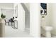 Bright hallway with stairs and a convenient half-bathroom leading to a dining area at 10822 Keato Beach Ct, Tampa, FL 33647