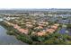 Stunning aerial view of a condo community with terracotta roofs, mature trees, and pond with fountain at 1117 Shipwatch Cir, Tampa, FL 33602