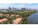 Panoramic aerial showcases charming waterfront community, mature landscaping, and the distant city skyline at 1117 Shipwatch Cir, Tampa, FL 33602