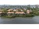 Expansive aerial showcases waterfront condo community with mature trees, offering a serene and lush atmosphere at 1117 Shipwatch Cir, Tampa, FL 33602