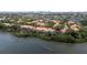 Aerial view highlights the waterfront community, lush greenery, and serene water views from multiple angles at 1117 Shipwatch Cir, Tampa, FL 33602