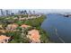 Scenic aerial view of waterfront condos with terra cotta roofs and lush landscaping, set against a skyline backdrop at 1117 Shipwatch Cir, Tampa, FL 33602