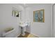Powder room featuring a pedestal sink, toilet, and decorative wall art at 1117 Shipwatch Cir, Tampa, FL 33602